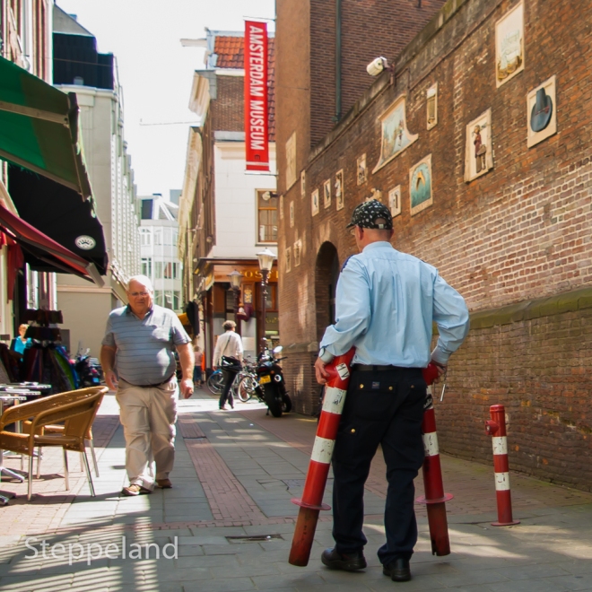 Amsterdam street photography, museum guard placing traffic poles 